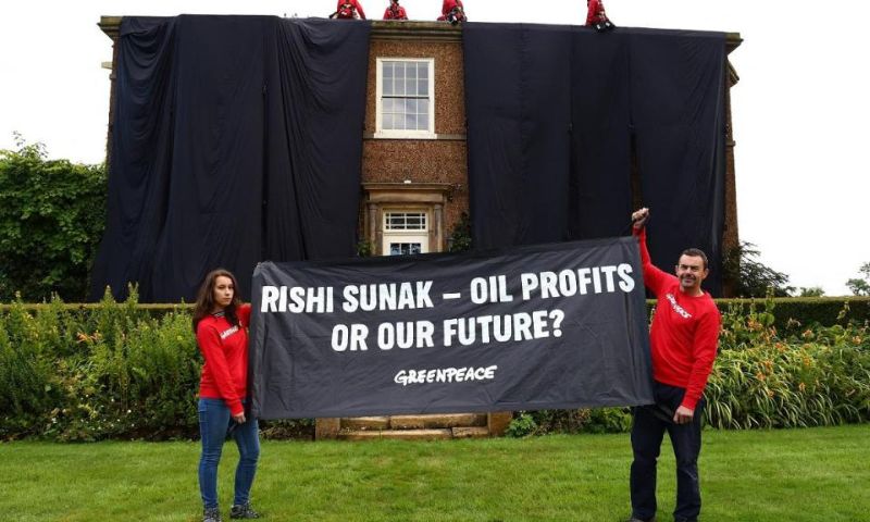 Environmental activists cover UK PM Sunak's home in black fabric