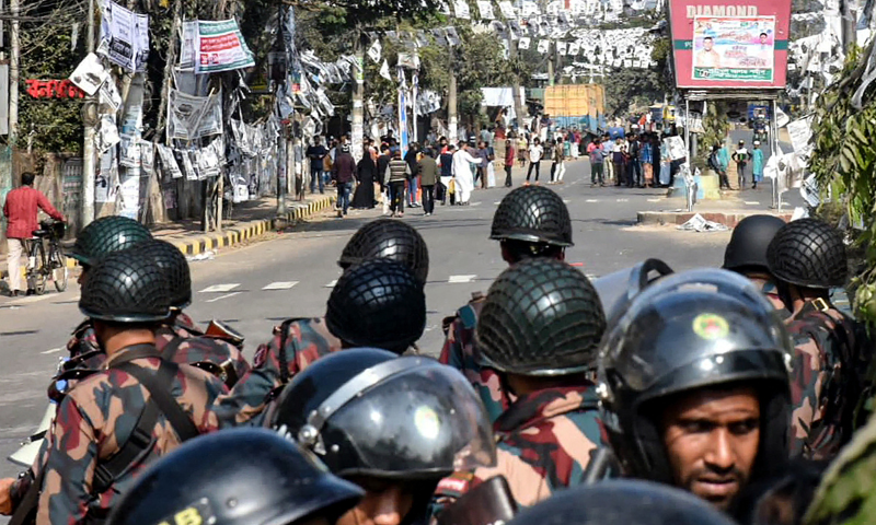 Rapid Action Battalion RAB personnel stand guard to disperse opposition activists staging a protest to condemn the ongoing general elections